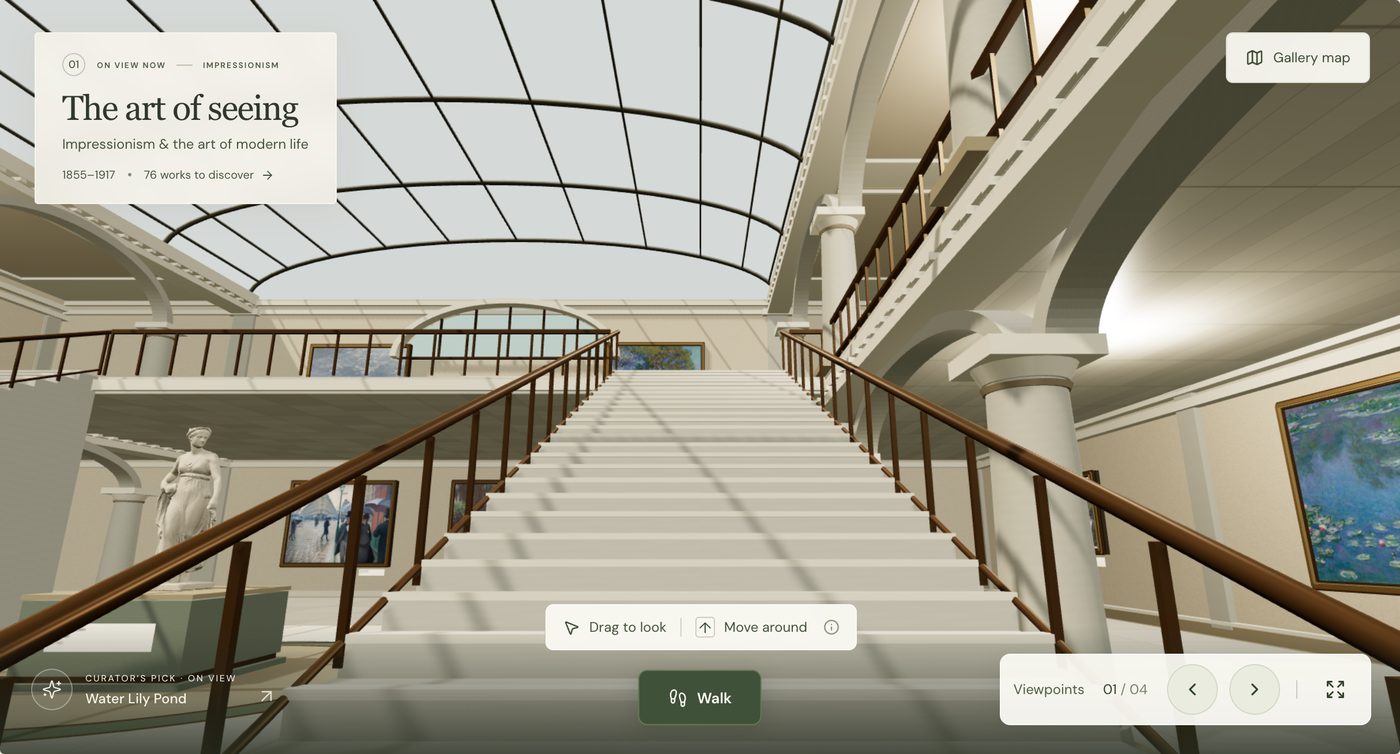 The grand staircase rising to the upper galleries under a glass roof.